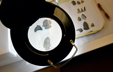 Inside the lab, artifacts, such as these projectile points, are carefully cataloged and analyzed